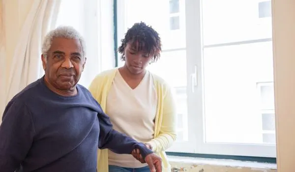 nurse helping elderly resident in nursing home
