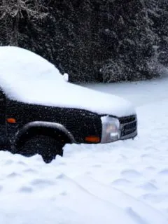 featured black car covered by snow