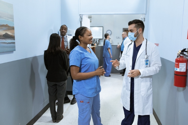 A nurse and a doctor communicating with each other in the hospital