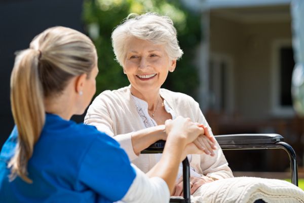 A nurse interacting with an elderly patient