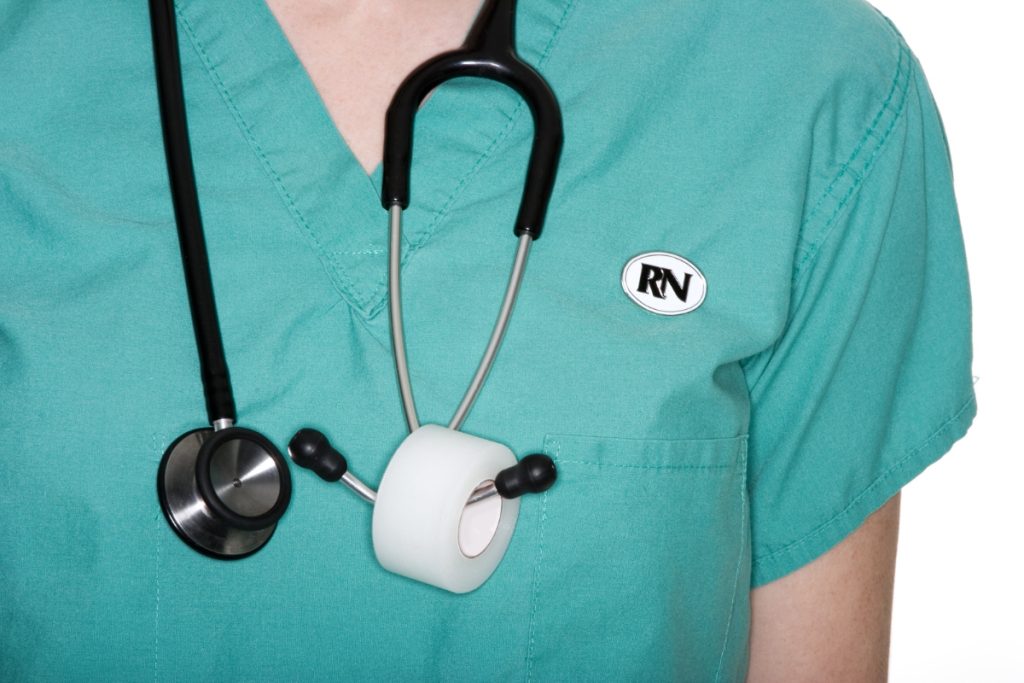 nurse wearing scrubs displaying RN