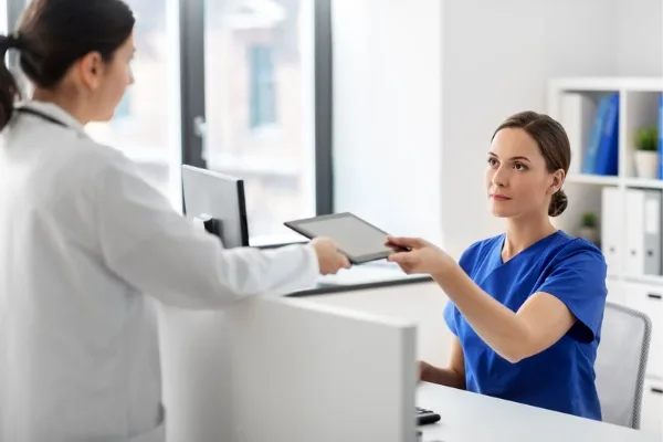 A nurse practitioner interacting with a doctor 