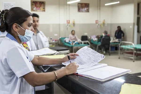 A nurses checking records in a hospital with earthquake victims