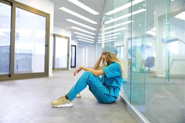 A tired nurse sitting in a hospital