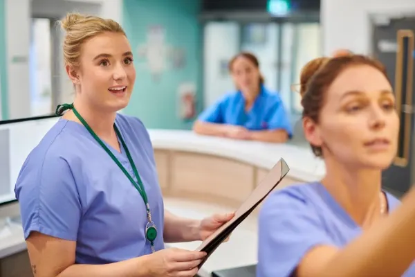 Nurses communicating and checking schedule