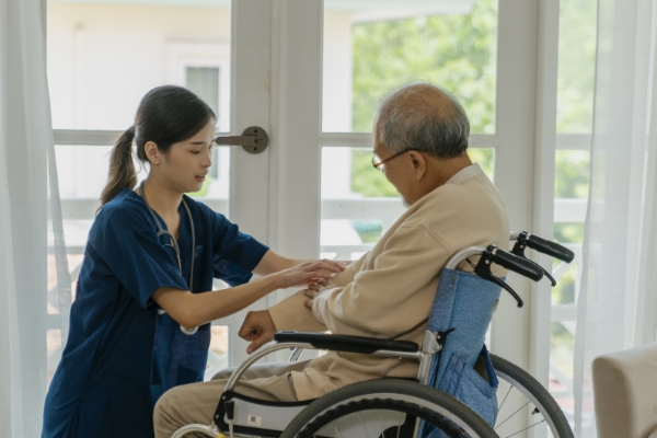 A hospice nurse assisting a elderly patient a Non-Traditional Nursing Jobs