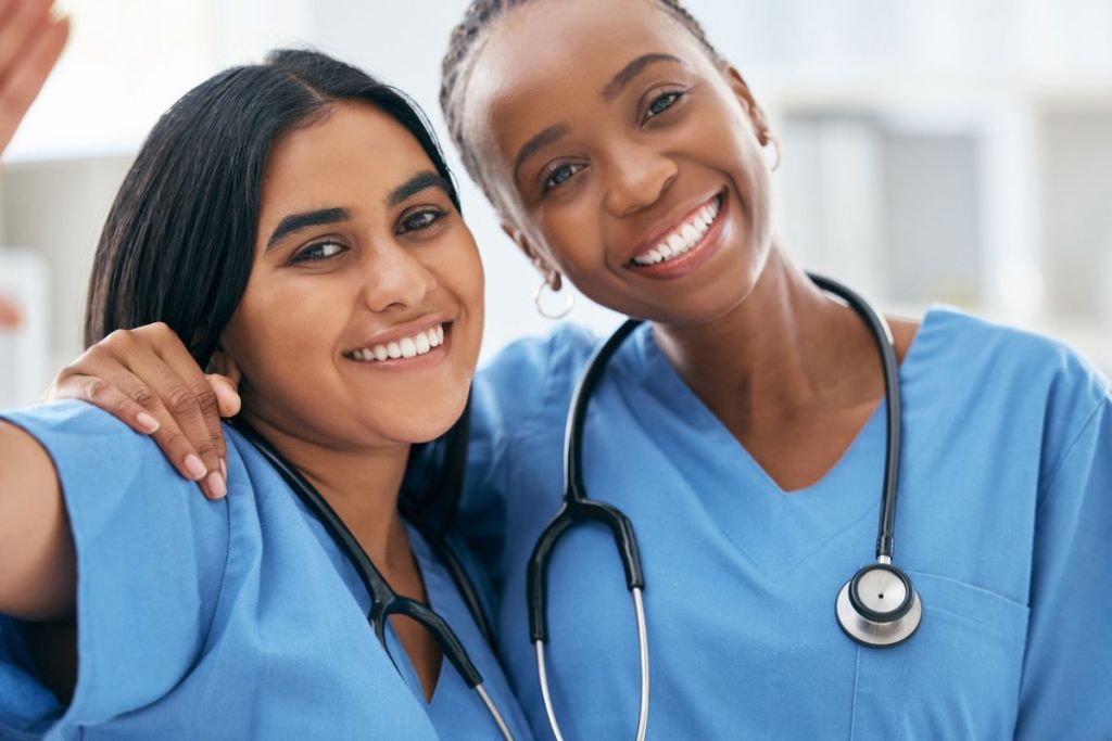 two nurses in blue scrubs with stethoscope